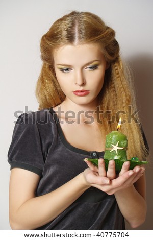 Romantic  young woman with candle, look down