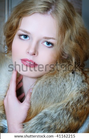 Young elegant girl with fur collar. Fur of a fox