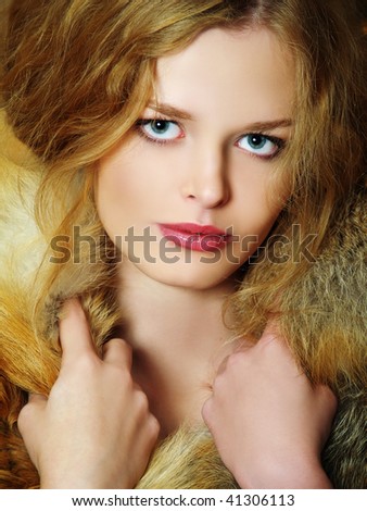 Young elegant girl with fur collar. Fur of a fox