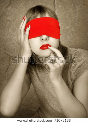 Portrait of a woman with covered eyes. Red lips and manicure