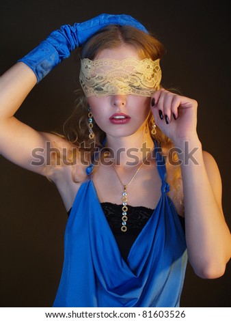 Portrait of a woman with covered eyes. Jewelry  and fashion