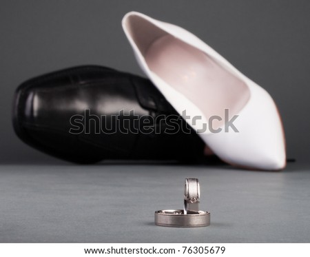 stock photo Wedding ring and shoes with gray background
