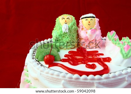Chinese birthday cake with old couple dolls.