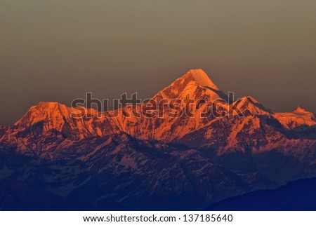 golden red shade of mountain Nanda Kot during sunset