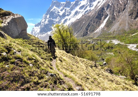 wide shot of high altitude trekking route with walking man
