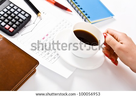 female officer holding white coffee cup during working time at office.