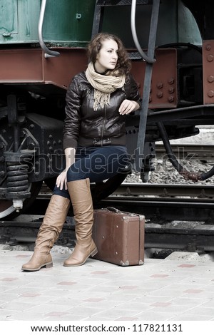 girl waiting for landing on the platform in the vintage train