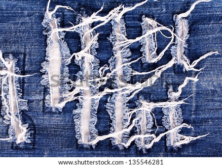 Creative embroidery on jeans, denim background