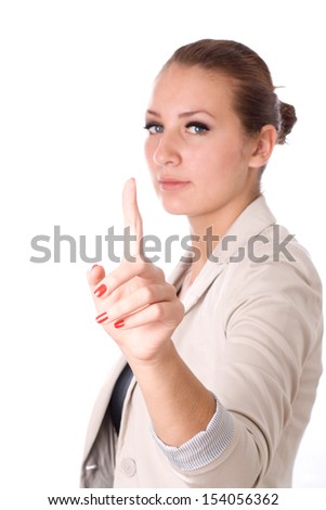 Happy young business woman pointing upwards