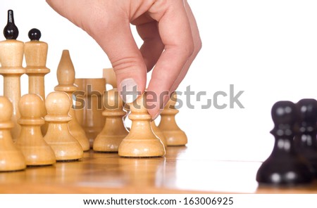 woman playing chess, and shows the hand of chess pieces