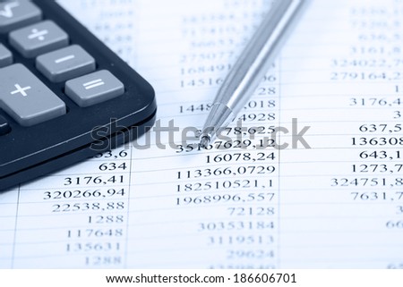 Black calculator with pen isolated on white