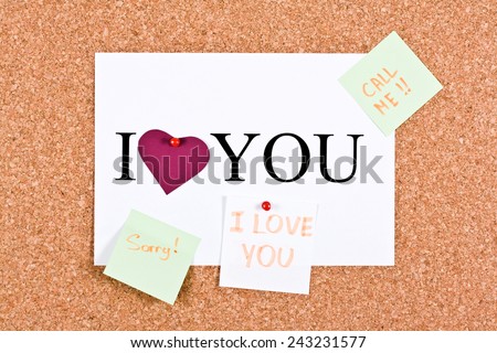 Cork board and a sheet with the words I love you, sorry, call me