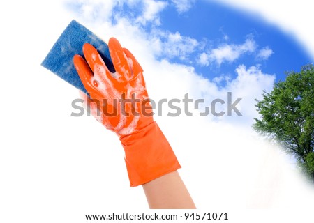 Hand in glove with sponge to clean the sky clears and the green