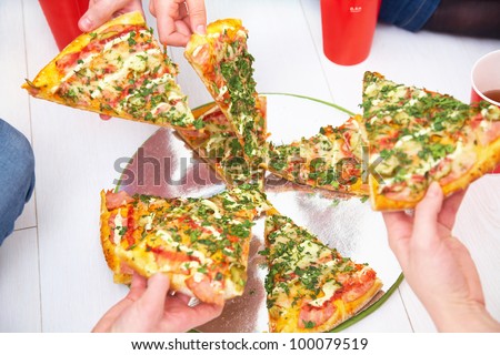 slices of pizza is lifted from human hands