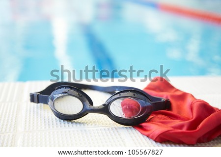 Image of swimming pool, goggles and swimming hat. Nobody