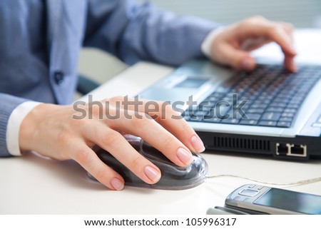 Human hands working on laptop on office background