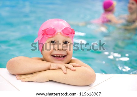 Portrait of little baby swimming  in swimming pool