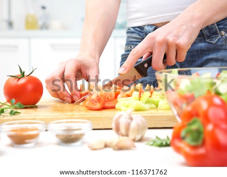 Human Hands Cooking Vegetables Salad In Kitchen