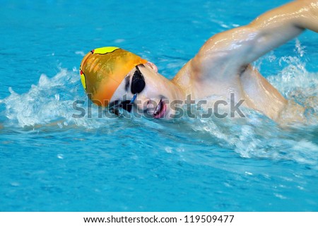 male professional competitive swimmer in swimming pool