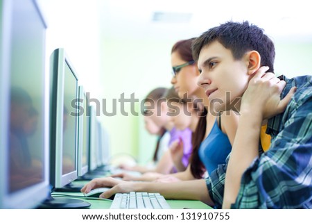 group of teens with computers