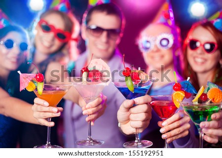 Five friends enjoying and having drinks at a night club