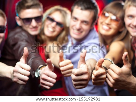 group of young people singing shows gesture OK at a party