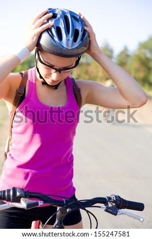 portrait of young sporty woman with bicycle outdoor