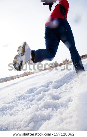 Athletic Man Running In Winter Day. Unrecognizable