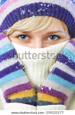 Winter portrait of beautiful smiling woman with snowflakes