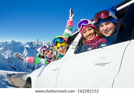 group of friends traveling by car on a vacation to the mountains