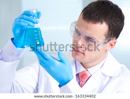 man scientist holding a test tube with liquid man scientist holding a test tube with liquid
