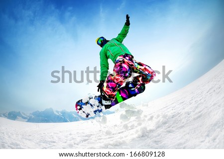 Snowboarder Jumping From The Mountain Along The Road Extreme