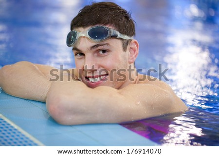 Young attractive man at the swimming pool