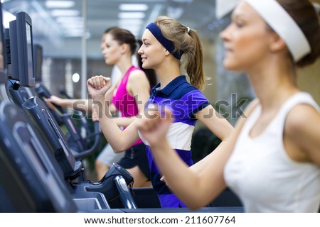 Healthy people doing fitness exercise in a sport center