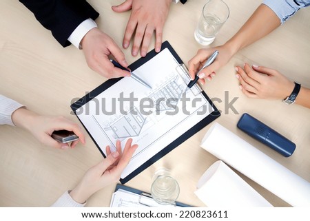 Hands of business people at the table at the meeting in the office. top view