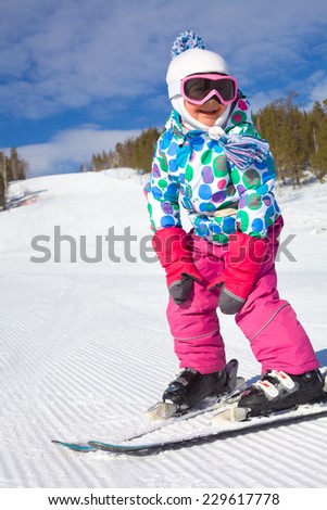 little girl learning to ski at the ski resort