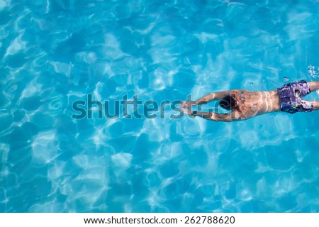 Young  man swimming  in the swimming pool