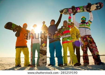 Group of young people with snowboard on ski holiday in mountains