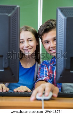 two young teenagers  in computing class