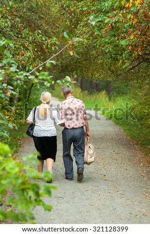 couple elderly people is on track in the green park
