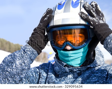 girl in ski helmet and mask in the ski resort