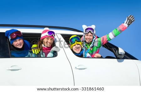 young friends   go to winter vacations in car