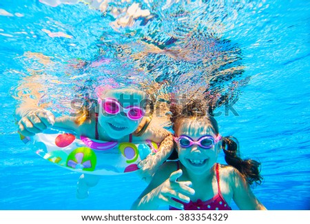 two little girls played under water in the pool