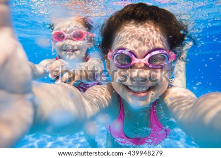 Pretty selfie  two little girls under the water.