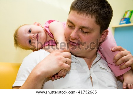Happy daddy and beautiful baby playing together