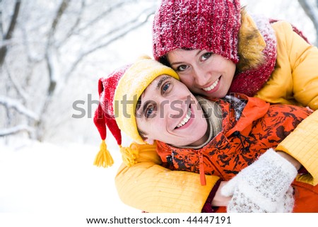 The young family plays winter wood on snow in Valentine\'s day