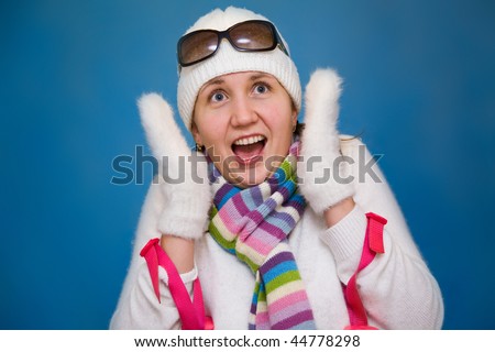 The beautiful woman screams with fear with mountain-skiing sticks in hands