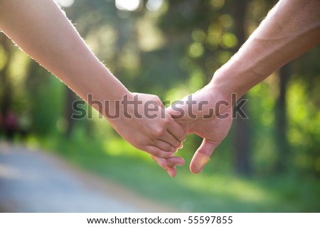 two pairs of hands in love tenderly hold together