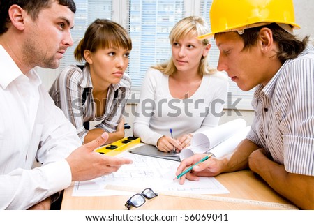 Meeting the team of engineers working on a construction project at the table