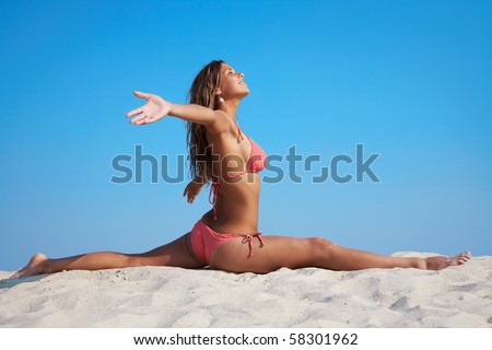 stock photo Mature sexy woman practicing gym by the beach